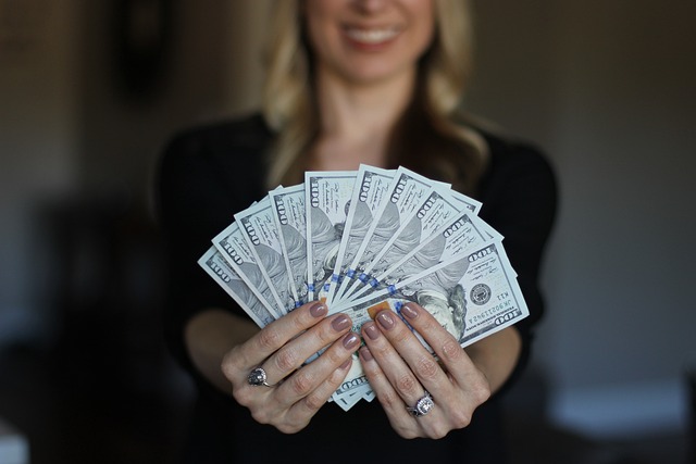 Wage rise woman holding cash