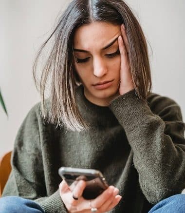 woman saddened by iphone message