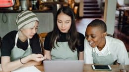 three young people at a laptop