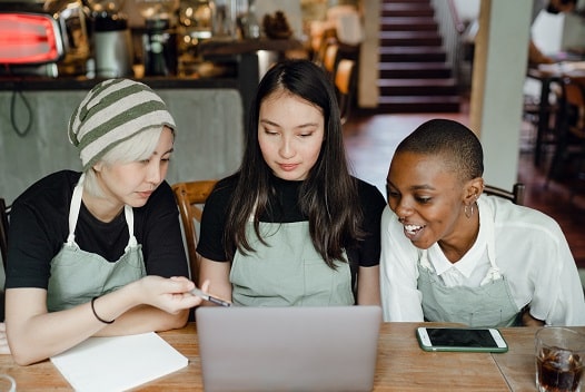 three young people at a laptop