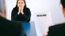 young woman facing a recruiter with CV