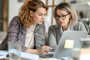Two women looking at a laptop
