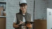 Woman in hard hat with clipboard