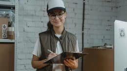 Woman in hard hat with clipboard