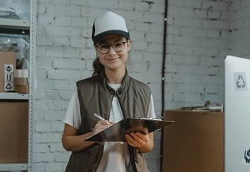Woman in hard hat with clipboard