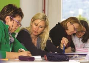 Three women at board table
