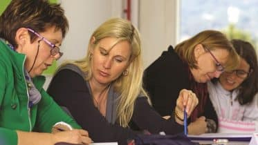 Three women at board table