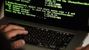 Anonymous hacker at computer screen